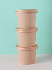 Eco cardboard round food box on table, mint green background