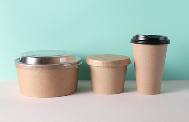 Cardboard takeaway food containers on mint green background