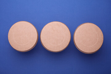 Eco cardboard round food boxes on blue background. Top view