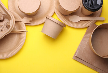 Many Cardboard disposable takeaway tableware on yellow background