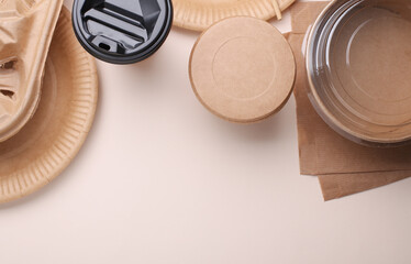 Many Cardboard disposable takeaway tableware on beige background. Top view. Copy space