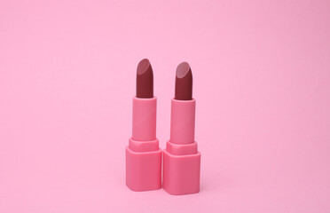 Pink lipstick tubes on pink background