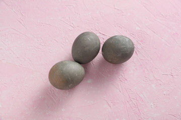 Easter eggs on a pink concrete background
