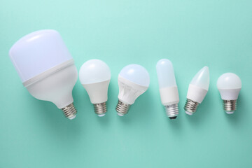 LED light bulbs of different shapes on a mint green background