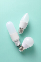 LED light bulbs of different shapes on a mint green background