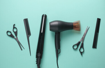 Flat lay hairdressing tools and accessories for hair styling on blue background. Top view