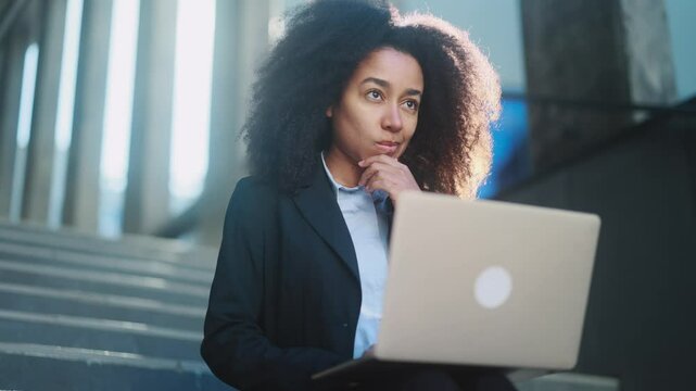 Portrait of beautiful young businesswoman thinks questioningly about difficult choice choose imagine plan in mind has doubts create idea with laptop computer at modern business centre	
