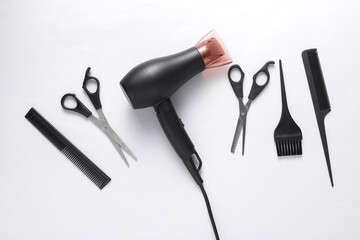 Flat lay hairdressing tools and accessories for hair styling on white background. Top view