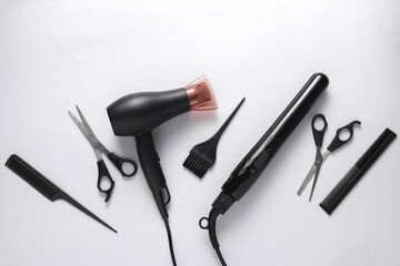 Flat lay hairdressing tools and accessories for hair styling on white background. Top view