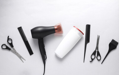 Flat lay hairdressing tools and accessories for hair styling on white background. Top view