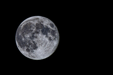 Full moon photographed with a telephoto lens.