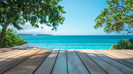 Fototapeta premium Wooden deck overlooking pristine turquoise ocean, framed by lush green foliage. Sunlight dapples the planks, creating an inviting tropical paradise vista.