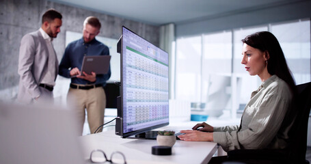 Accountant Using Bill Spreadsheet At Desk