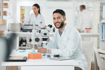Fototapeta premium Scientist, man and portrait by microscope in lab study, stats or smile for results with pride for research. Person, happy and excited for progress, pharmaceutical innovation or medicine in Costa Rica