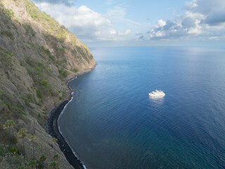 Obraz premium The scenic and rugged coastline of the island of Komba lies 70 km north of the Lesser Sunda Islands of Indonesia. This remote island, surrounded by reef, is an active volcano that often erupts.