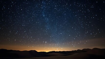Naklejka premium 42. A vast night sky filled with stars above a serene desert landscape