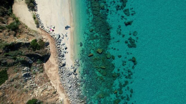4K Aerial drone video of one of the most beautiful beaches in the world with turquoise clear blue water and white sand with big rocks on a sunny summer day. Marinella di Zambrone Paradiso Tropea Italy