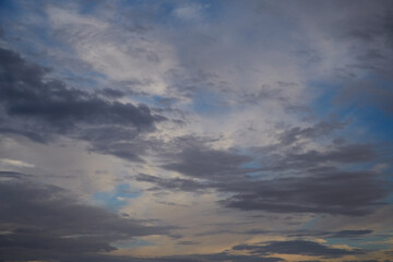 Gray puffy clouds cover the blue sky, windy weather, sky after a storm