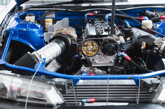 Close-up of modified high-performance car engine intricate components, vibrant colors, and advanced technology Perfect for automotive enthusiasts and engineering