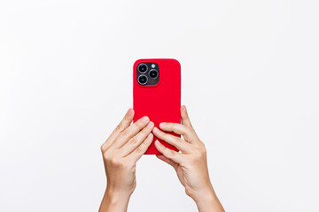 Mobile phone with 3 photo cameras in a red color case in female hands isolated on a white...