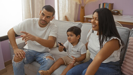 Family watching television together in a cozy living room featuring a man, woman, and child enjoying quality time indoors