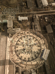 Vertical photo.Dangerous work at height.Construction site of a power plant a chimney.A renovation is smokestack.Contractor repairing at a highrise.Workers in a hard hat.Work at the high skypaper site