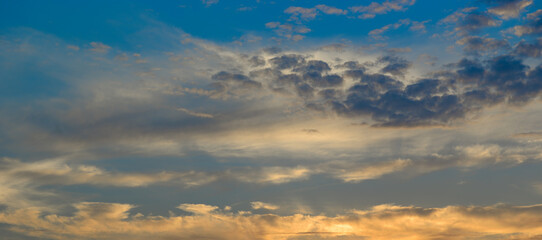 Sunrise sky with lighted clouds. Wide photo.