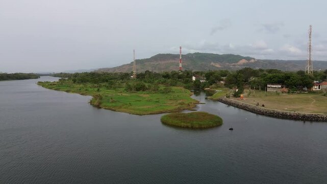 aerial view of a tiny island floating on a large river