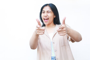 Fototapeta premium excited asian woman pointing finger showing presenting gesture wearing casual clothes isolated on white background