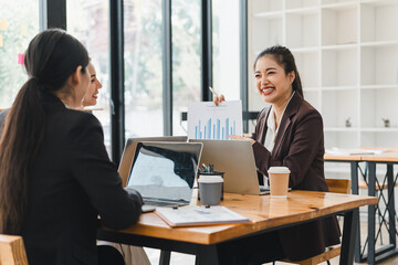 businesswoman presents graph to her colleagues during meeting, showcasing teamwork and collaboration in modern office setting. atmosphere is professional and engaging