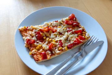 Authentic delicious slice of vegetarian pizza for healthy lifestyle of vegetarians and vegans with fast food snack as piece of pizza with paprika and sweet corn and cheese topping as delicious snack