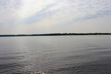 The calm lake on a sunny foggy morning.