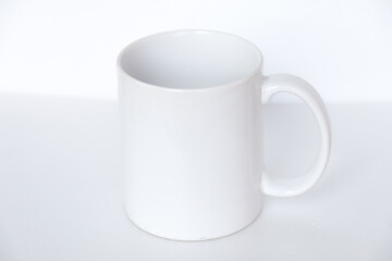 Elegant white ceramic mug isolated on a blank background, suitable for product marketing, mockups, and graphic design