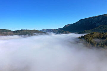 Aerial view of autumn morning mist and clouds in the valley