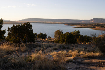 View of Abiquiu Lake, an Army Corps of Engineers reservoir in northern New Mexico, with pinyon and juniper trees at dawn