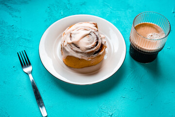 Traditional northern European dessert Cinnamon roll on plate on wooden background