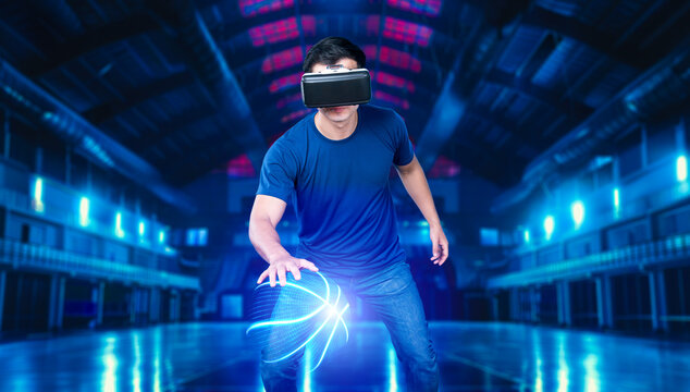 Basketball player bouncing basketball hologram at futuristic sport arena. Energetic athlete or sport person practicing basketball skill by using augmented reality technology. Innovation. Ingenuity.