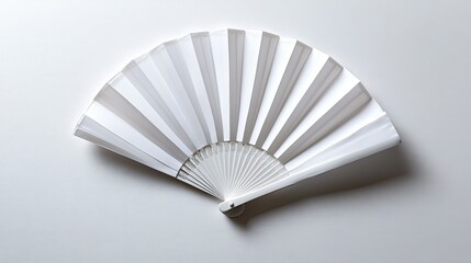 A flat lay of a white folding hand fan, fully opened against a clean white background, showing all details.