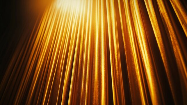 A low angle view of a golden curtain with light shining through it.