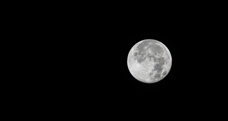 Fototapeta premium Full White Moon isolated on black sky or background with copy space 
