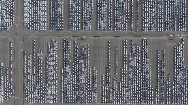ASAN, SOUTH KOREA - OCTOBER 16, 2024: Aerial view of a massive car storage lot in Asan showcasing numerous vehicles arranged in rows