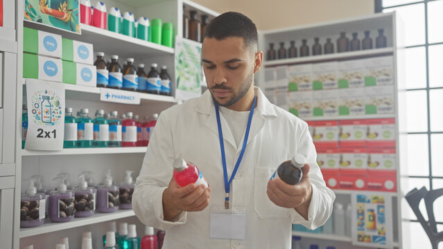A professional hispanic man comparing products in a pharmacy, surrounded by shelves filled with various items.
