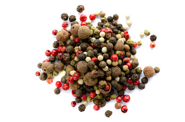 Mixture of black, red, white, green, allspice peppercorns isolated on white background, top view. Peppercorns of different colors on a white background, top view. Pepper mix.