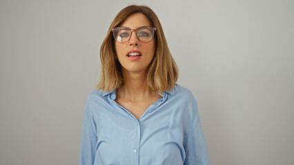 Attractive blonde woman wearing glasses standing isolated against a white background