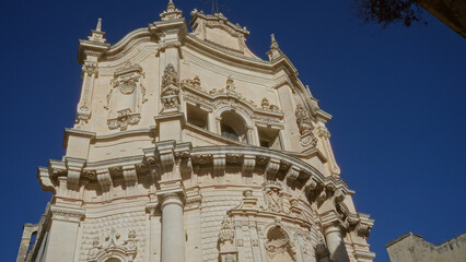 Fototapeta premium Stunning baroque architecture of lecce, italy with intricate details against a clear blue sky in puglia, europe.