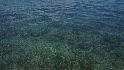 Clear blue water with visible rocky seabed in porto cesareo, a beautiful coastal area in puglia, salento, italy.