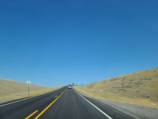 Scenic Open Road Through Golden Landscape