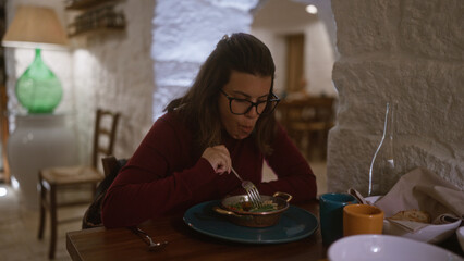 A young hispanic woman enjoys a meal in an authentic italian restaurant with rustic decor indoors.