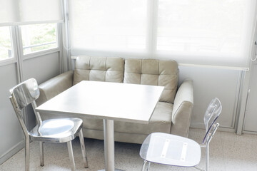 Aluminum chair and gray sofa in restaurant,Contemporary interior design of light spacious dinning room,modern furniture in living room or office,copy space.