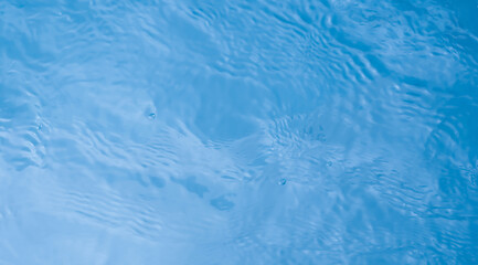 Water texture background, Summer blue sea ocean with soft ripple, Top view empty swimming pool or water in bathroom with circle pattern surface and abstract white light effect for Cosmetics product